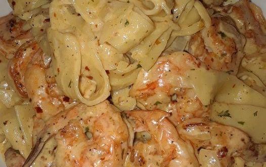 Cremige Garnelen-Nudeln mit Alfredo-Sauce und Garnelen in Pfanne serviert