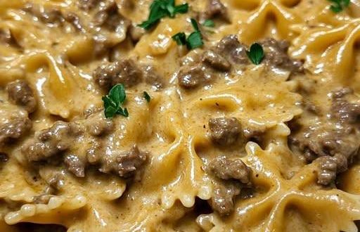 Cremige Rinderhackfleisch-Bowtie-Pasta in einer weißen Schüssel, garniert mit frischer Petersilie