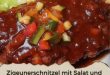 Paprika-Schnitzel mit Salat und Pommes auf Teller serviert